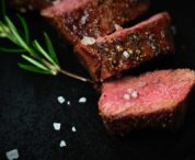 searing steaks in a pan