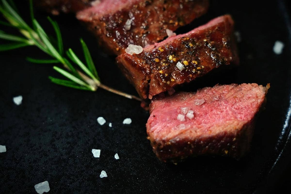 searing steaks in a pan